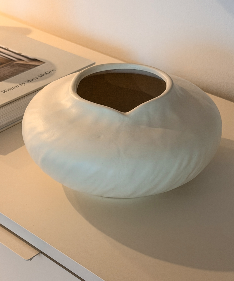 Runde Keramikvase Maira in warmem Cremeweiß auf dem Sideboard – Detailansicht